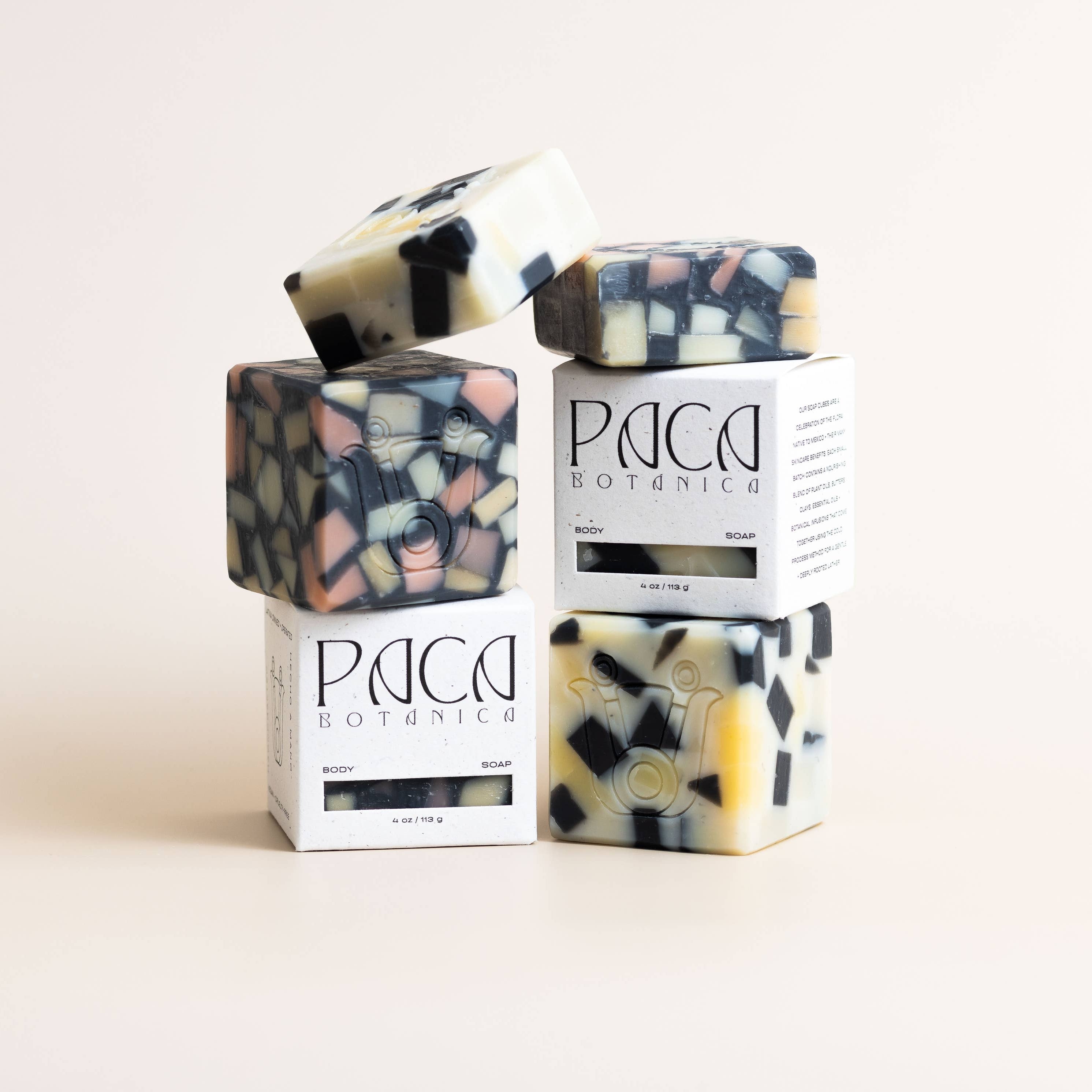 Colorful soap bars with 'PAIGE' packaging on a light background