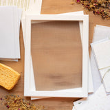 Wooden picture frame on a wooden surface with stationery items.