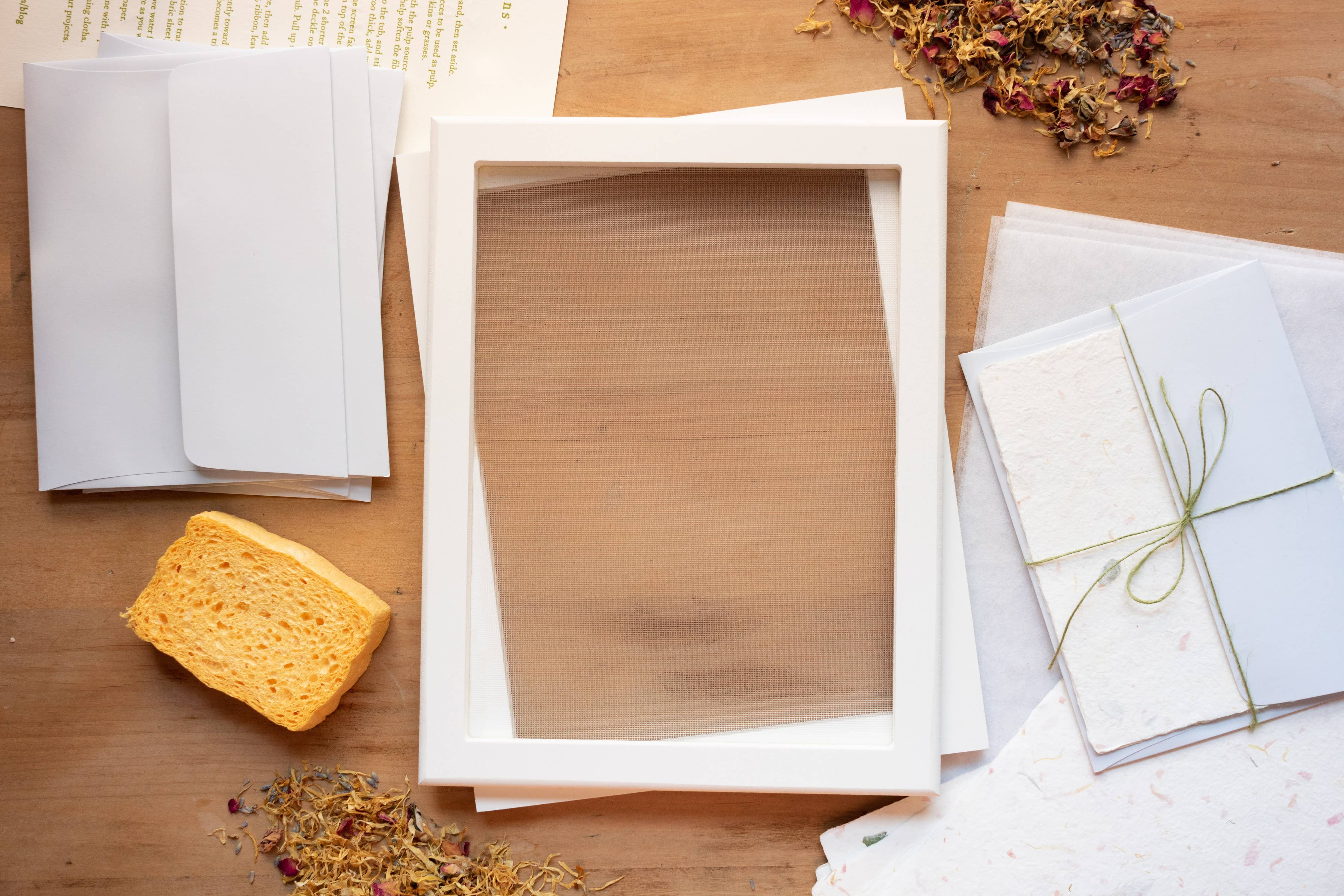 Wooden picture frame on a wooden surface with stationery items.