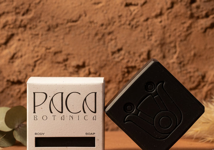 Black soap bar and its packaging on a white background