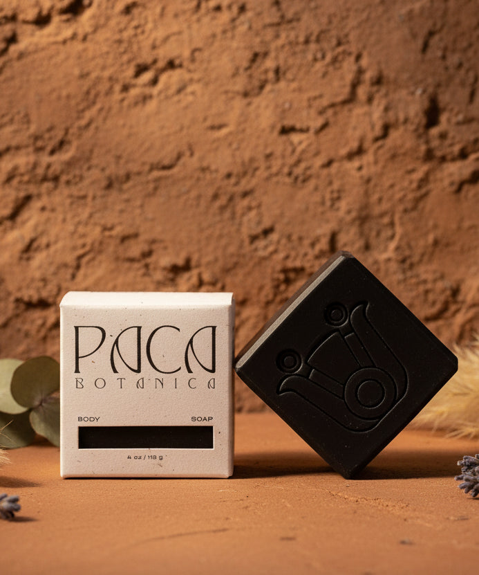 Black soap bar and its packaging on a white background