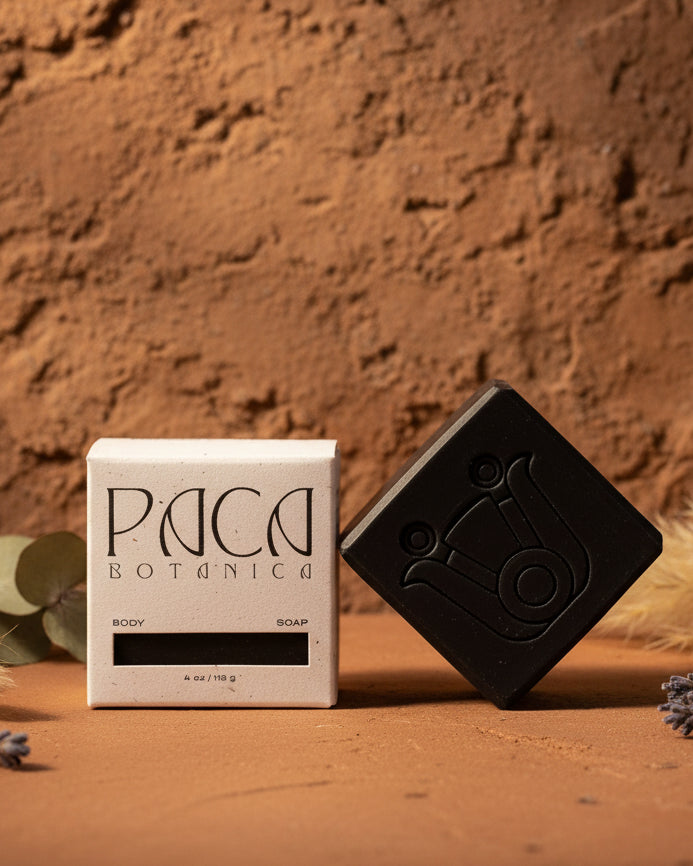 Black soap bar and its packaging on a white background